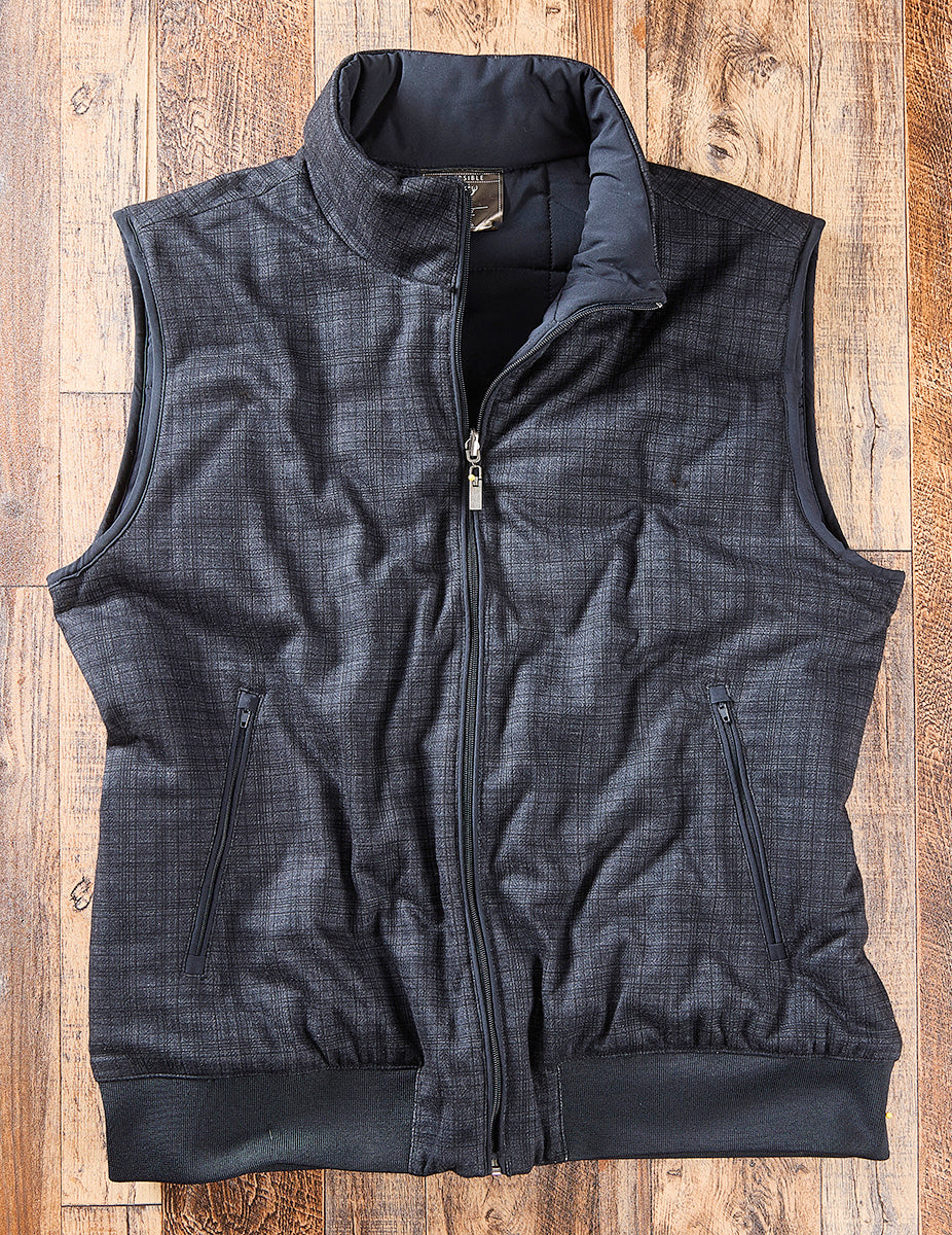 Navy Nicoby reversible puffer vest shown on its textured plaid side
