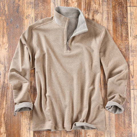 A beige quarter-zip long-sleeve shirt with a gray ribbed inner collar and cuffs.